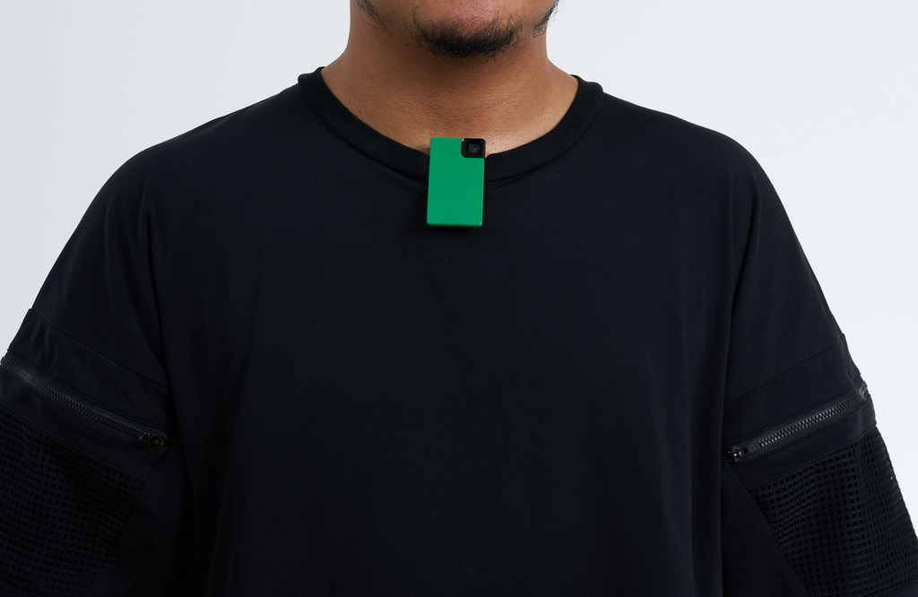 Person wearing a black shirt with a green Saveclip